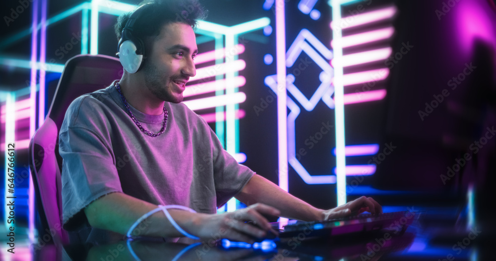 Excited Handsome Man Playing Video Games with Friends on a Computer, Surrounded by Cyberpunk Style Background. Concept of Internet Streaming, Gaming, Streaming and Social Network
