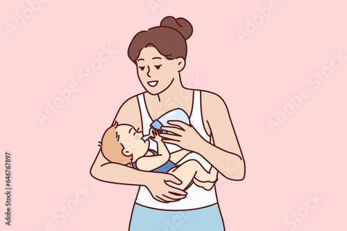 Young mother feeds infant from bottle using artificial baby food fortified with vitamins due to disease hypogalactia. Happy mom takes care of son or daughter and gives baby milk from pacifier