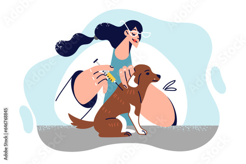 Female veterinarian gives injection to dog to vaccinate puppy against rabies or infections