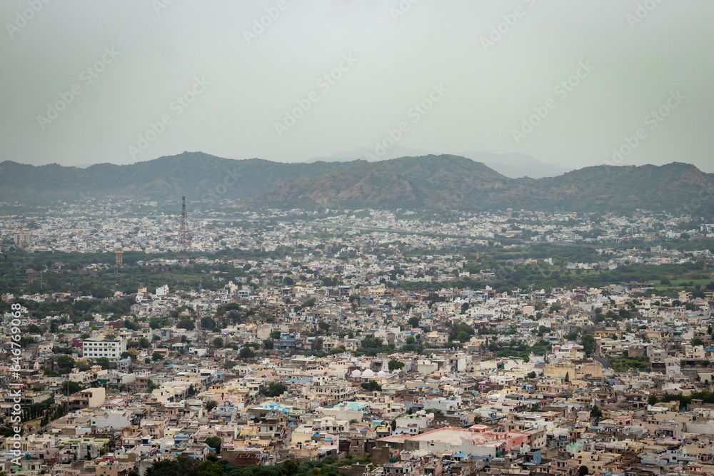 crowded city houses landscape with misty mountain background at morning from flat angle