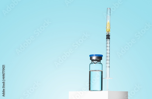 Glass Medicine Vial jar botulinum toxin with medical white injectable syringe on blue background. A preparation for cosmetology rejuvenating procedures, biorevitalization, mesotherapy, anti age. Mock 