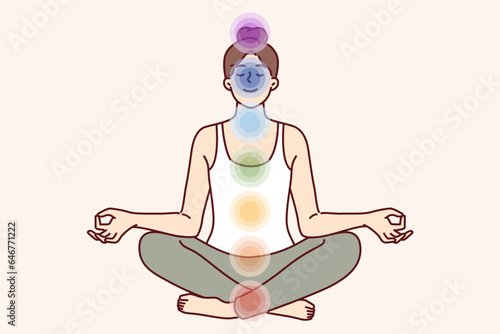Meditating woman sits in lotus position and does yoga, feeling changes in aura and surge of vitality. Girl uses yoga practices to open seven chakras that affect health and psychological state