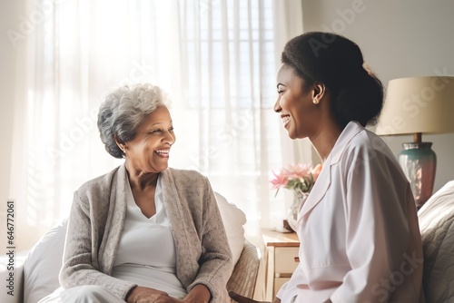 African american woman Doctor talking to a senior woman in bedroom modern white home