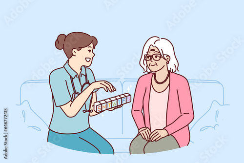Doctor prescribes medication to elderly female patient and holds pills with smtwtfs letters. Organizer for pills in hands of therapist caring for grandmother suffering from sclerosis