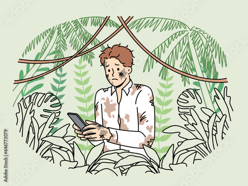 Dirty lost man office employee holding mobile phone and standing in jungle trying to send sos signal. Lost businessman suffers due to lack of GPS network in forest and feels helpless in wild