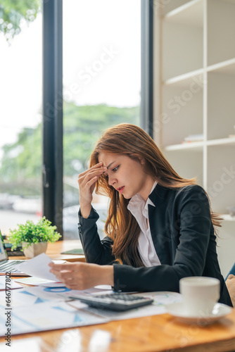 Business asian women are stress while working on laptop, Tired business woman with headache at office, feeling sick at work