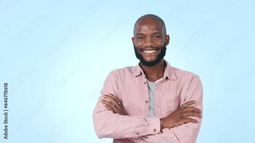Face, fashion and black man with with arms crossed, smile and aesthetic on a blue studio background. Portrait, African person and model with stylish outfit, cheerful and casual with cool clothes Face, fashion and black man with with arms crossed, smile and aesthetic on a blue studio background. Portrait, African person and model with stylish outfit, cheerful and casual with cool clothes