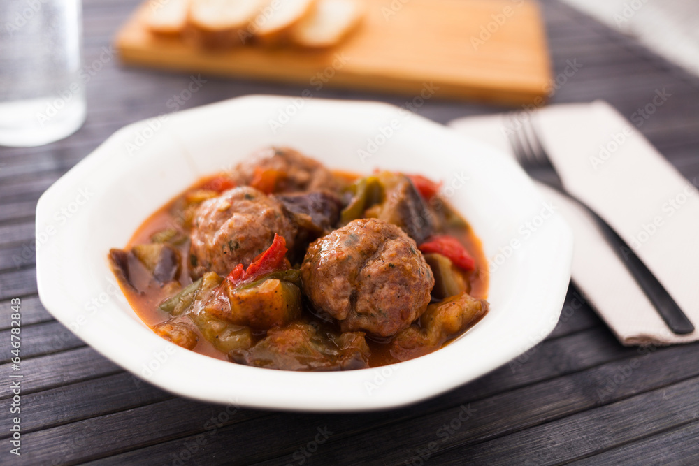 Steamed meatballs with stewed vegetables on plate