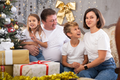 Portrait of family who is satisfied of gifts in time celebration New Year at home