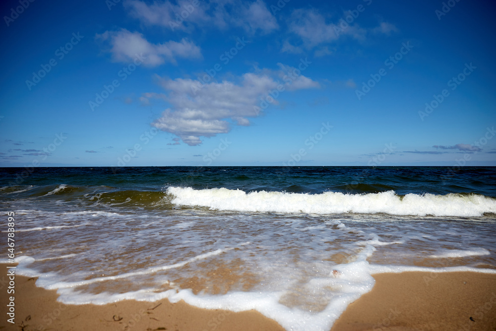 Beautiful beach with sand, tuquoise sea and blue sky with some clouds in synny summer day, selective focus Beautiful beach with sand, tuquoise sea and blue sky with some clouds in synny summer day, selective focus