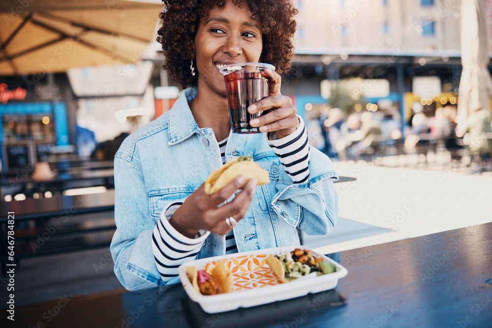 Laughing woman enjoying a drink while eating tacos on a restaurant patio Laughing woman enjoying a drink while eating tacos on a restaurant patio