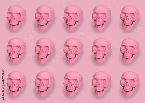 pastel pink skulls pattern on pink background halloween concept