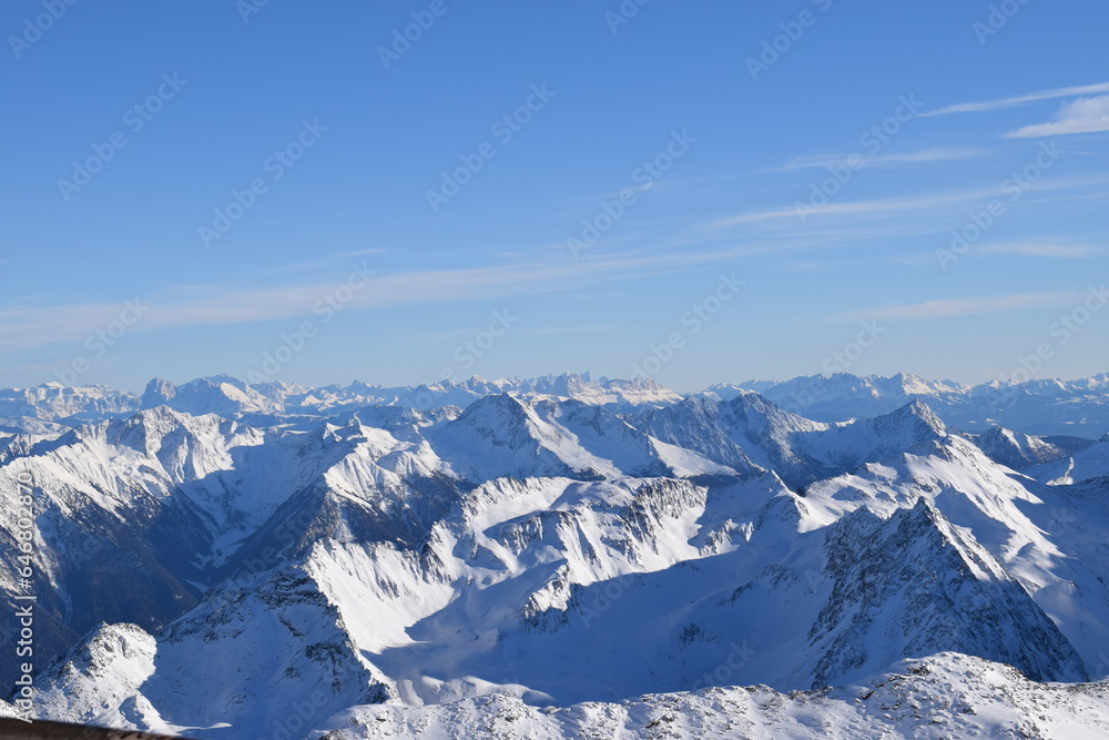 Stunning view from the Top Mountain Star restaurant at the peak of Hochgurgl Ski Resort, Austria. Beautiful snow capped mountain peaks of the Ötztal Alps and Italian Dolomites