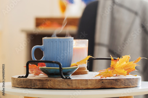 cup of coffee in cozy interior with autumnal decor