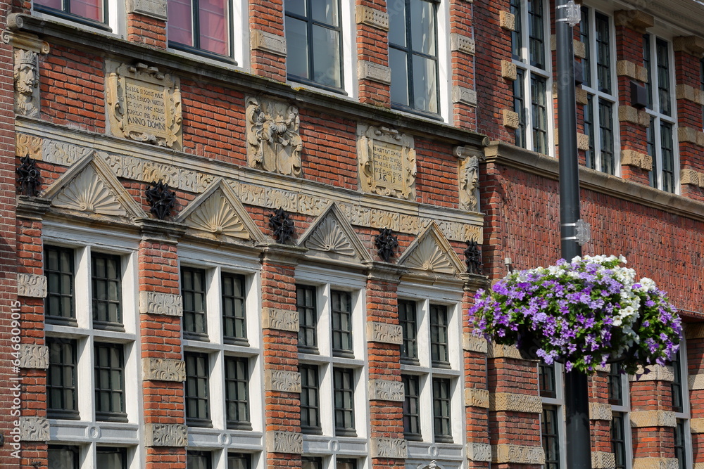 Naklejka premium Traditional historic medieval house facades with carvings in the old picturesque town of Zutphen, Gelderland, Netherlands, located on Houtmarkt street 