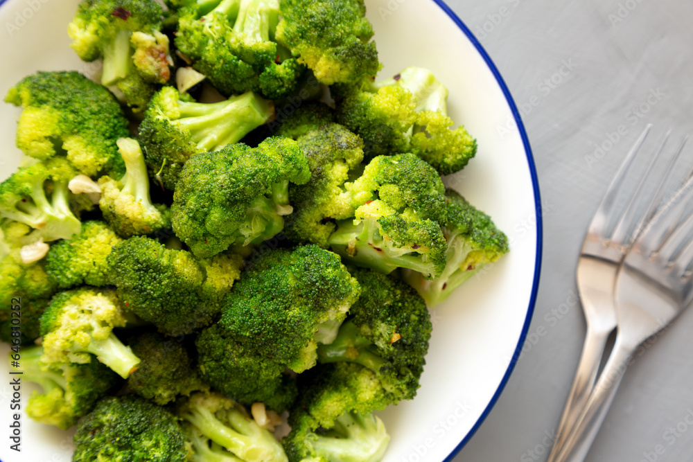 Homemade Pan-fried Broccoli on a Plate on a gray background, top view. Homemade Pan-fried Broccoli on a Plate on a gray background, top view.