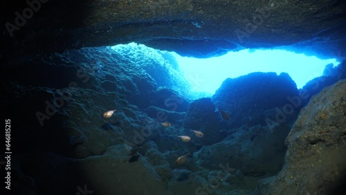 sun ray and sun beam scenery underwater cave divig with some fish photo