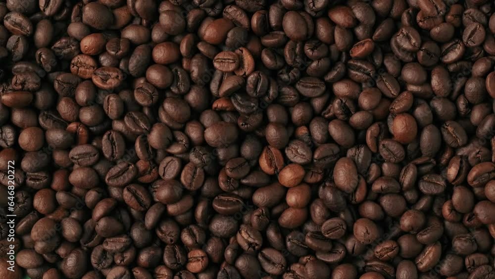 Closeup shot of roasted coffee beans scattered on green background being blown by the wind. Chroma Key. Closeup shot of roasted coffee beans scattered on green background being blown by the wind. Chroma Key.