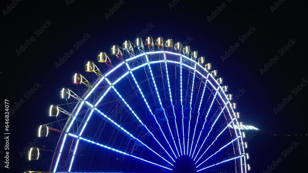 Ferris wheel lights in evening amusement park, ferris wheel lights. World's ferris wheel in Vietnam in night lights on Island at Vinpeerl. Top view aerial ferris wheel in amusement park at night. 4K. Ferris wheel lights in evening amusement park, ferris wheel lights. World's ferris wheel in Vietnam in night lights on Island at Vinpeerl. Top view aerial ferris wheel in amusement park at night. 4K.