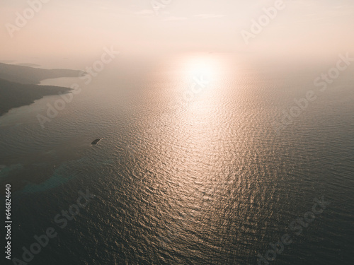 Beautiful aerial sunset view over sea surface beautiful wave. Amazing light sunset or sunrise sky over sea beach with wave crashing in the ocean.nature background