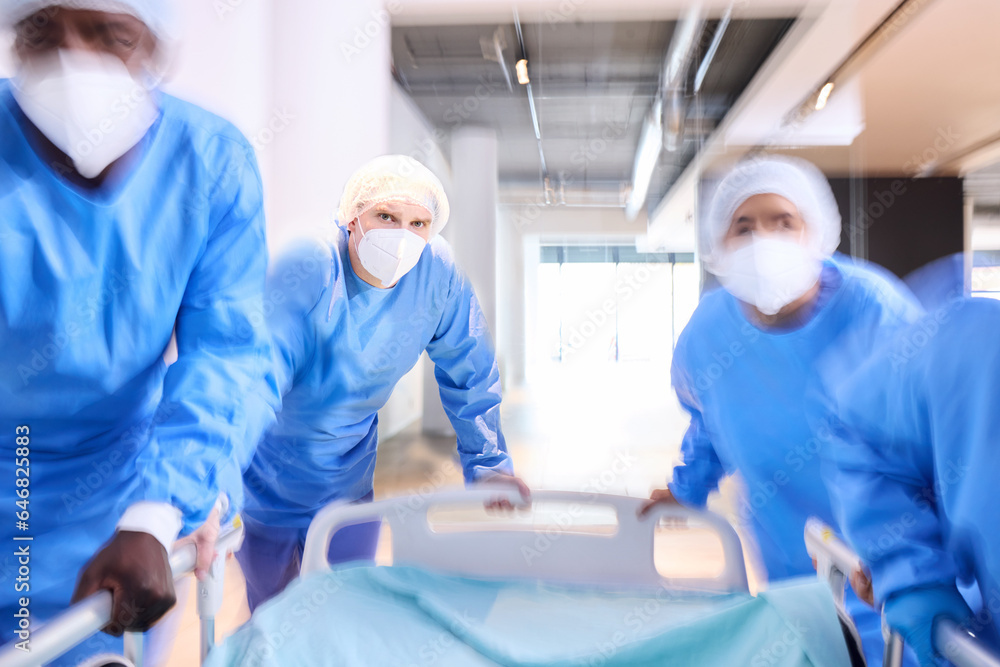 Obraz premium Emergency, hospital bed and surgeon team, healthcare staff or group running for surgery, clinic services or medical help. Injury collaboration, fast motion blur or doctors rush for accident first aid