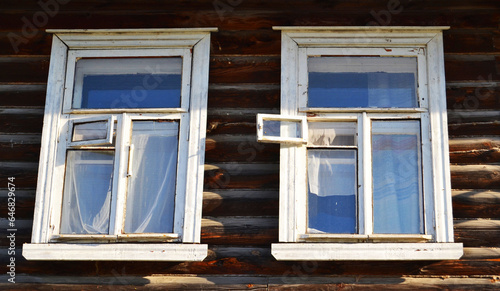 Old wooden frames on the windows in a wooden house. photo