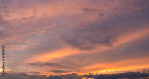  Panoramic view of sunset golden and blue sky nature background. Colorful dramatic sky with cloud at sunset.Sky background.Sky with clouds at sunset.