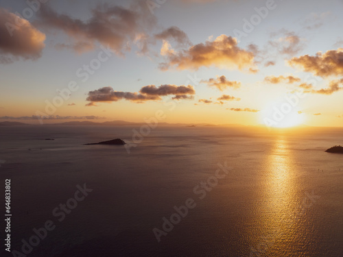 Aerial sunset view of Langford Island  Whitsunday Islands  Queensland  Australia  near Great Barrier Reef. Popular tourist destination near Hayman Island. Queensland mainland coast in the background.