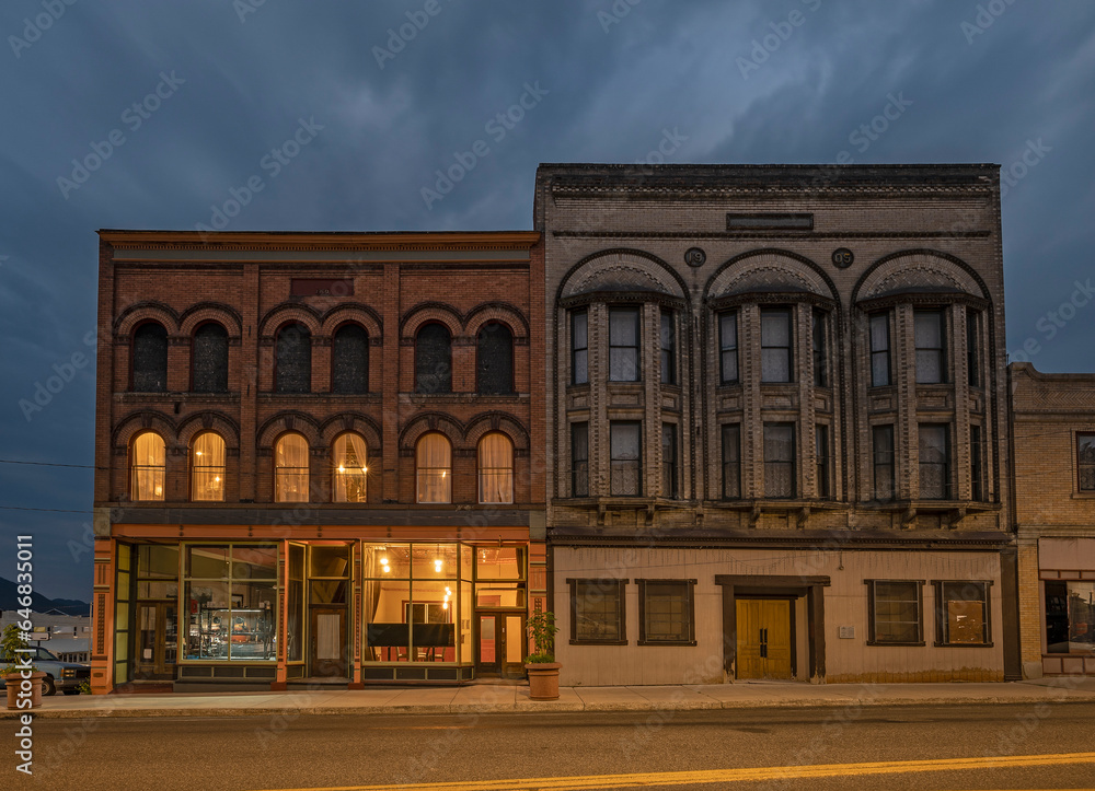 Illuminated historic brick buildings at night in downtown Butte, Montana, United States