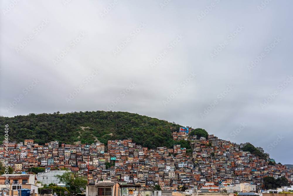 Astonishing Favela in Rio de Janeiro Rising Over Mountain against Cloudy Sky