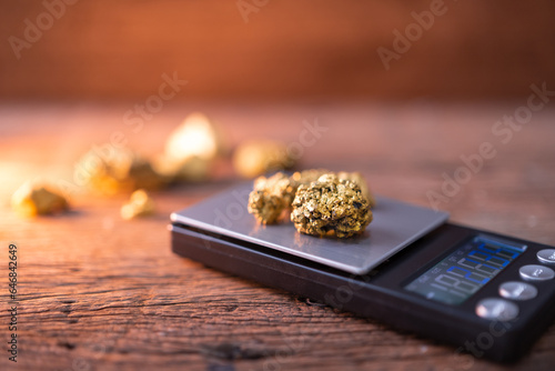 pure gold ore from a mine is placed on a weighing scale for evaluation.
