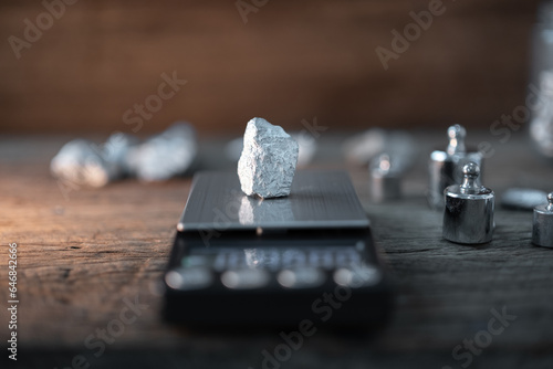 silver or platinum or rare earth element mine place on a standard weighing scale.