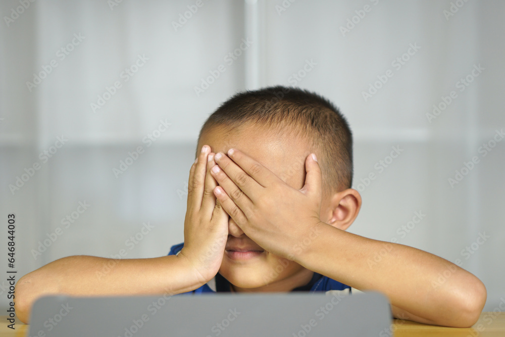 Boy has eye strain from looking at computer for a long time Boy has eye strain from looking at computer for a long time