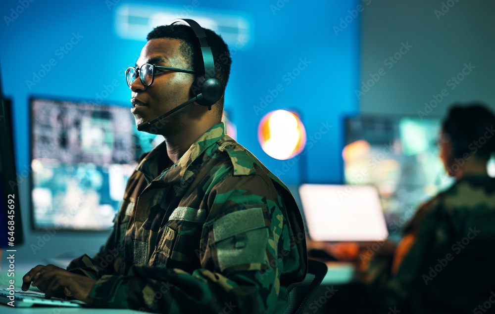 Army, control room and man on computer in office, data center and monitor for technical support, cybersecurity or surveillance. Military, officer or work in tech, security or government communication Army, control room and man on computer in office, data center and monitor for technical support, cybersecurity or surveillance. Military, officer or work in tech, security or government communication