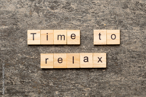 time to relax word written on wood block. time to relax text on table, concept