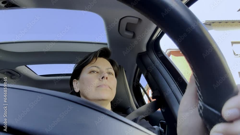 Front View of a Woman Driving a Car with Sunroof in Switzerland. Front View of a Woman Driving a Car with Sunroof in Switzerland.