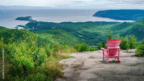 Red adirondack chair at the top of Franey hiking trail, Cap Breton Highlands national park, Nova Scotia, Canada