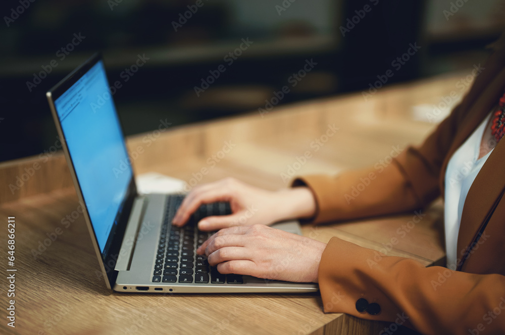 Businesswoman in a suit works on a laptop. Businesswoman in a suit works on a laptop.