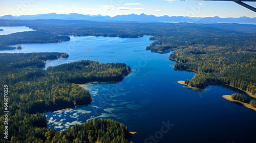 Birds view of beautiful lake from on a summer day. Forest, trees sunshine. © AllistairBot/Peopleimages - AI