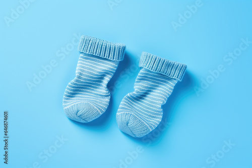 Pair of small baby socks on blue background with copy space for text, Minimalistic post card for baby shower