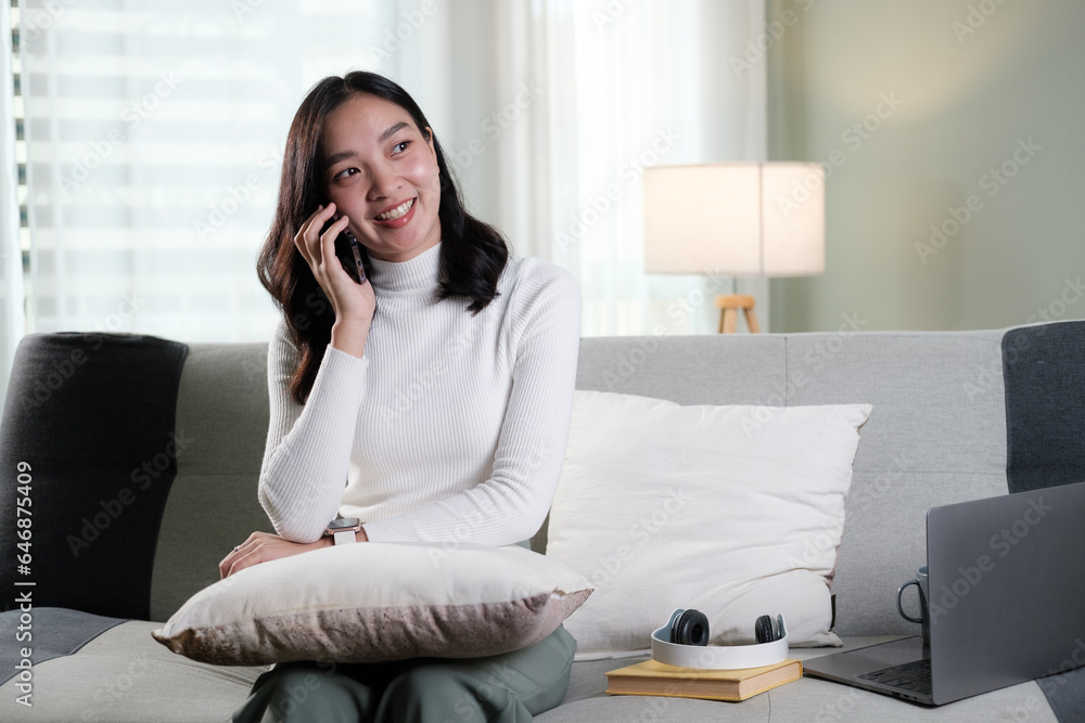 Attractive Asian woman resting comfortable living room and using mobile phone, Relax, Sofa, Lifestyle Attractive Asian woman resting comfortable living room and using mobile phone, Relax, Sofa, Lifestyle