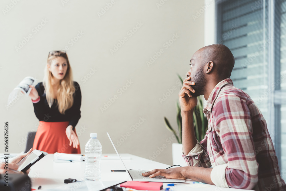 two colleagues multiethnic working indoors discussing two colleagues multiethnic working indoors discussing