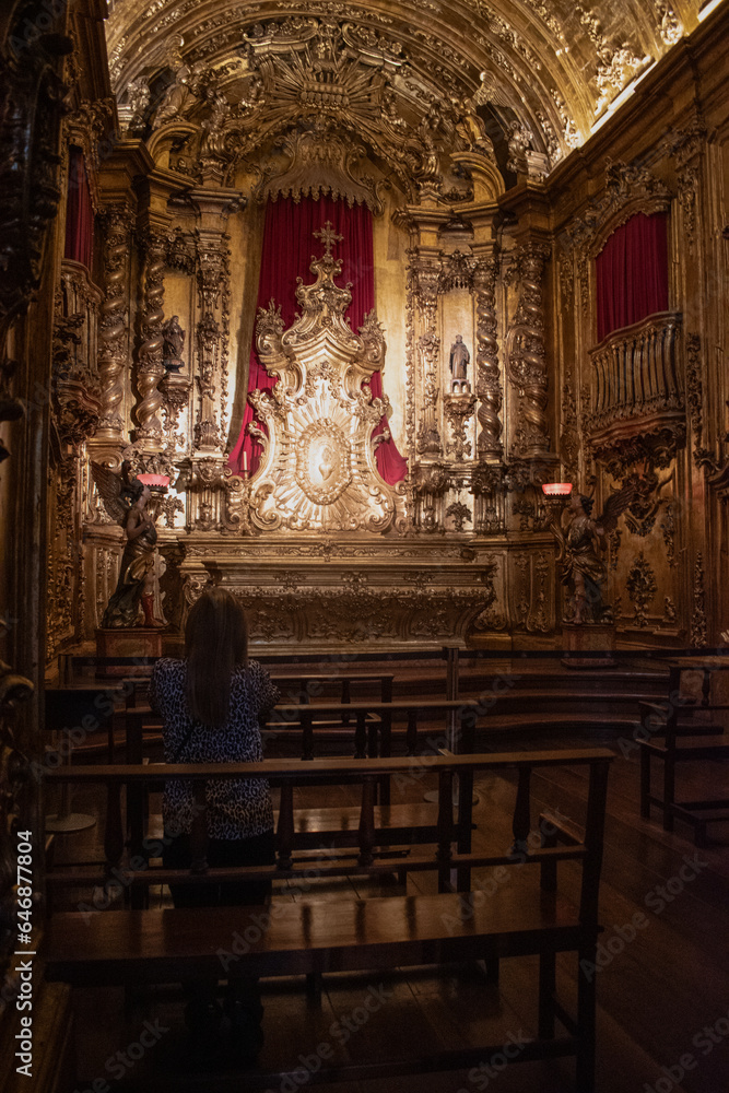Rio de Janeiro, Brazil: woman from behind praying in the Chapel of the Blessed Sacrament in the Abbey of Our Lady of Montserrat (Monastery of St. Benedict), Benedictine abbey founded by monks in 1590 