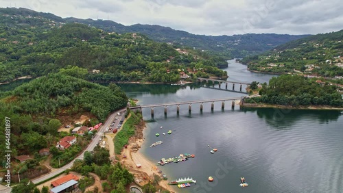 A beautiful Aerial view of a bridge over the Cavado River in Peneda-Geres National Park, Portugal photo