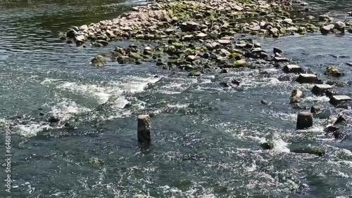 Water flowing through rocks in the Bengawan Solo River photo