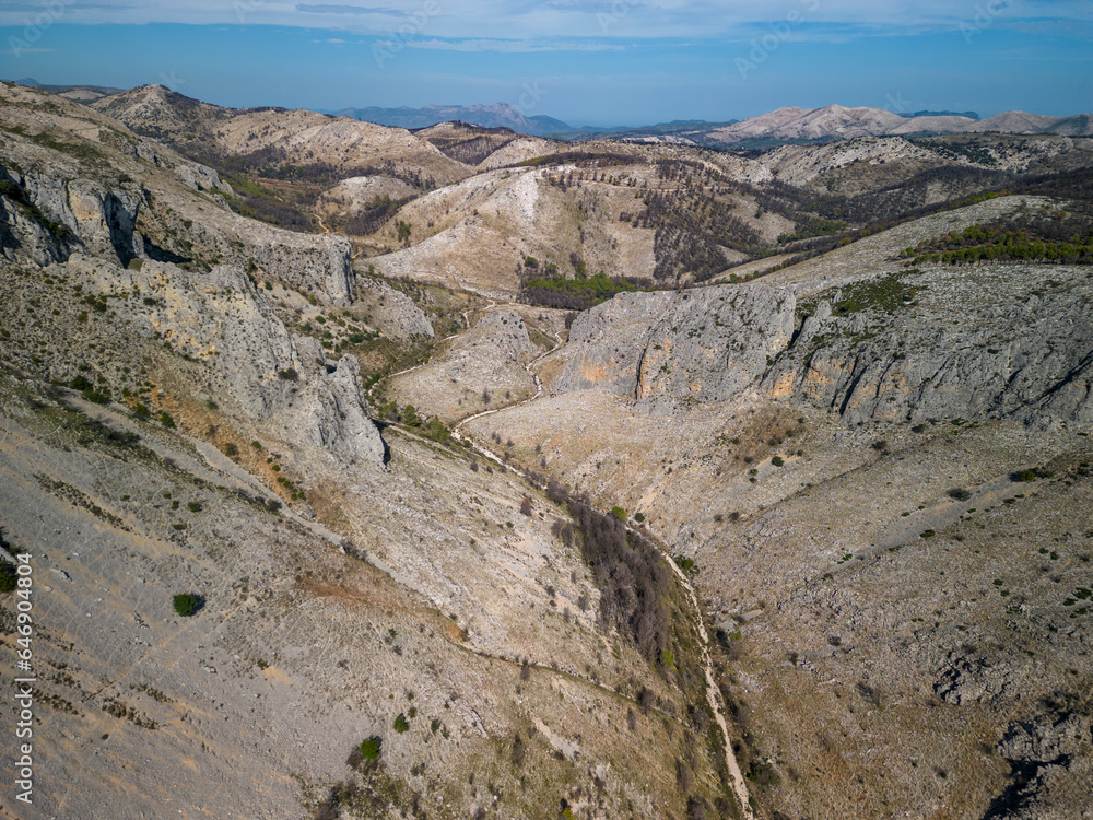 Aerial view of Malafi ravine in Serra D'Alfaro with burnt wooded area on the mountains, Tollos village, Alicante, Costa Blanca, Spain- stock photo