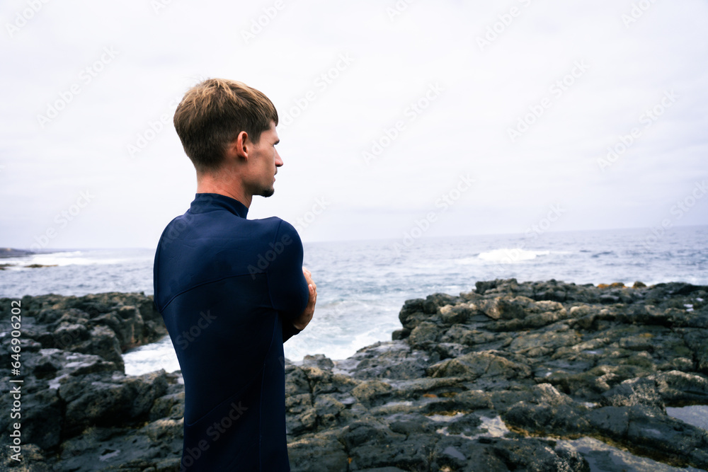 happy surfer in the coast with his red surfboard happy surfer in the coast with his red surfboard