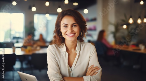 successful  happy  and confident businesswoman sits at her computer at her desk with a positive attitude. While working  a beautiful  healthy female entrepreneur or a creative  trustworthy boss smiles