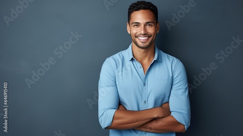 an attractive and self-assured young man poses against a gray background  photo