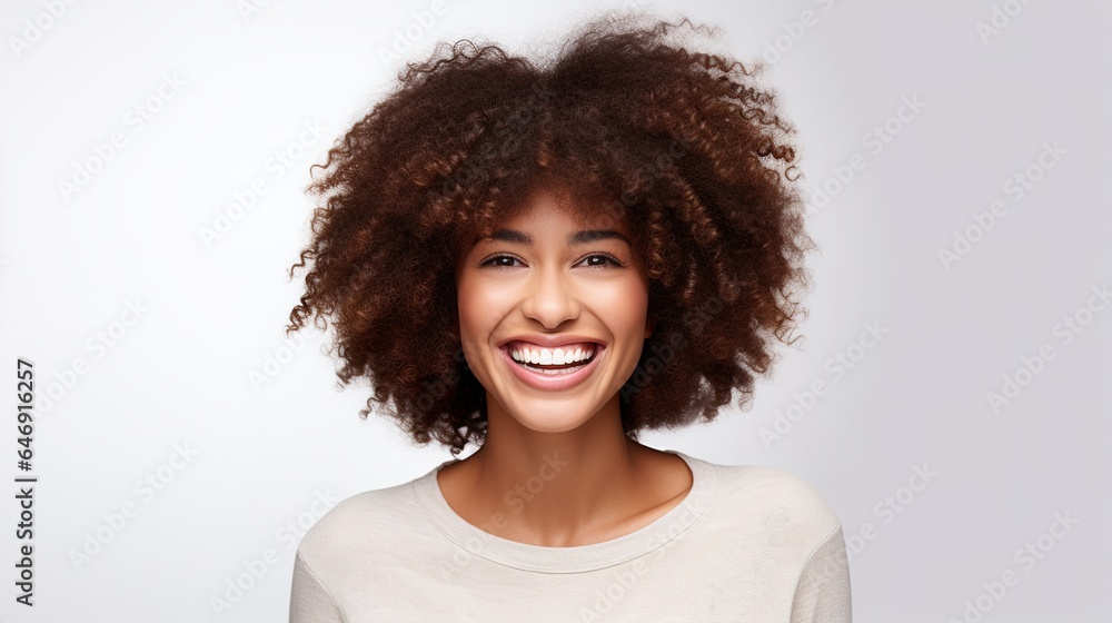 young trendy beautiful mixed race woman with an afro smiling and posing on white background young trendy beautiful mixed race woman with an afro smiling and posing on white background